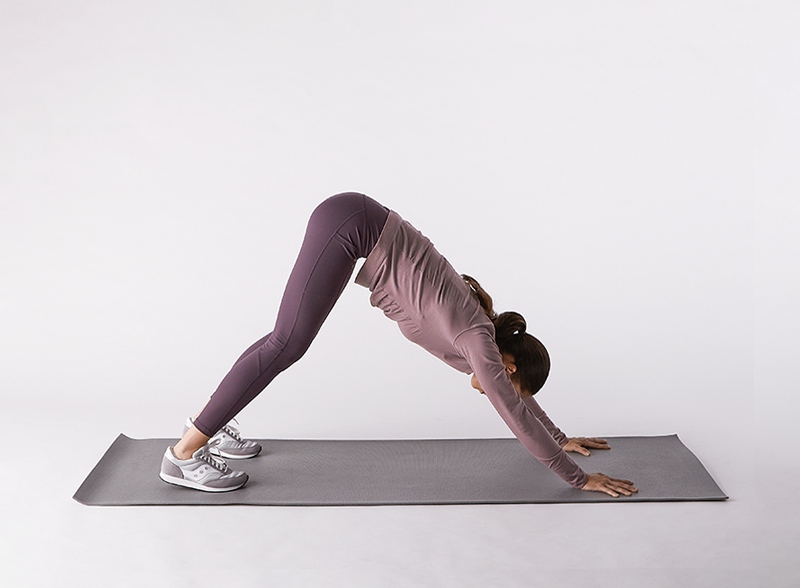 Woman-in-workout-clothes-doing-downward-dog-position