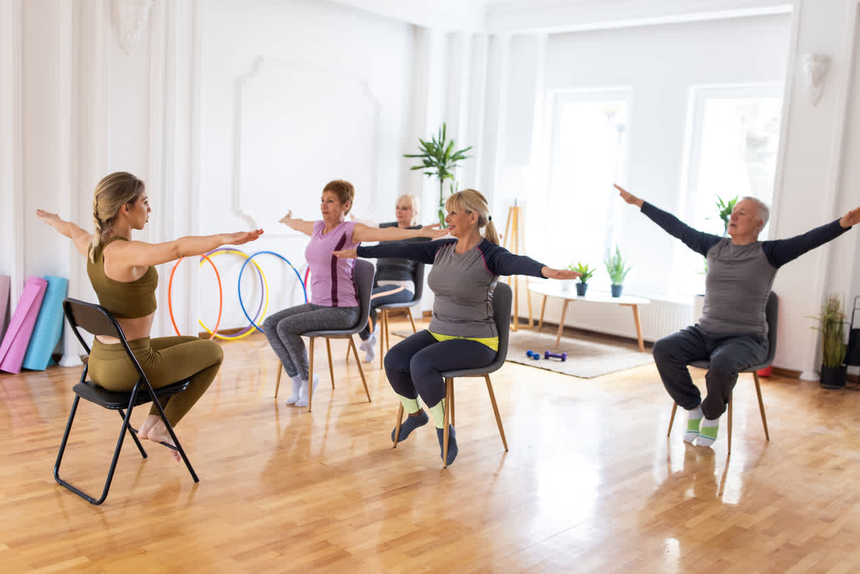 Four-elder-people-doing-seated-excerises-with-a-personal-trainer