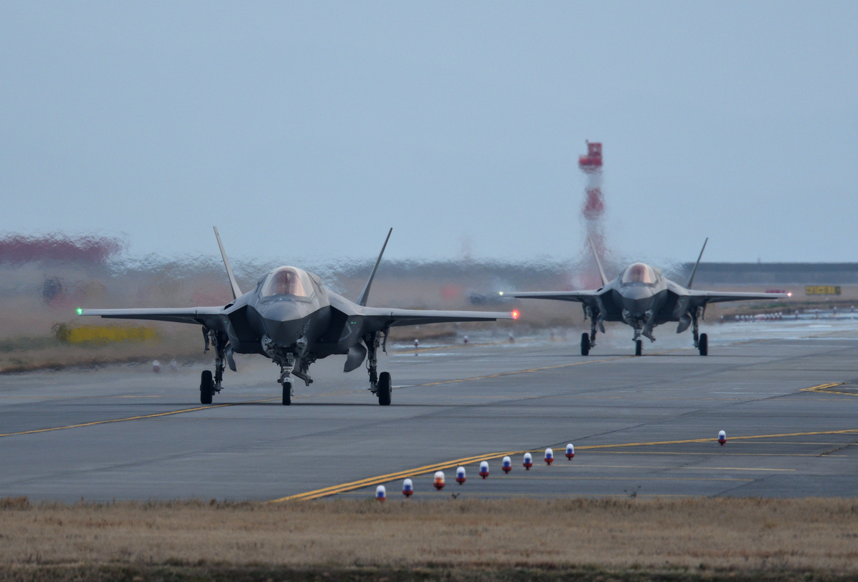 Two fighter jets on a runway
