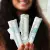 The girl is smiling and holding 3 tampons in her hand