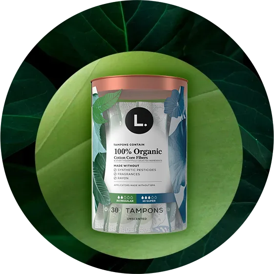 L. Tampons container labeled Organic Cotton Core with text stating made without fragrances, rayon, or synthetic pesticides, and applicator made without BPA.