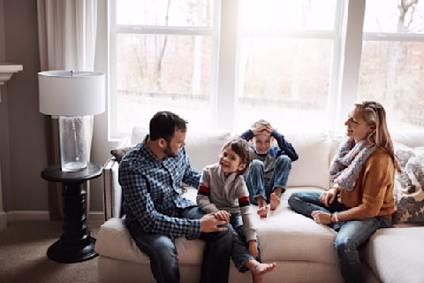 A family sitting together on a couch A family sitting together on a couch
