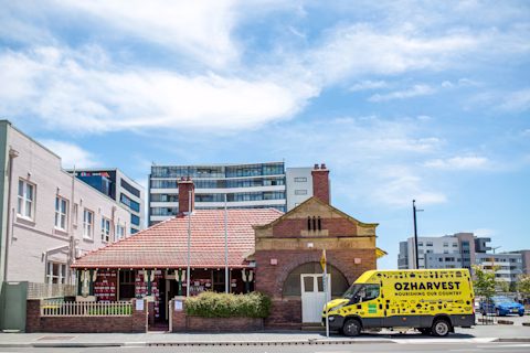 OzHarvest truck parked in front of a home OzHarvest truck parked in front of a home