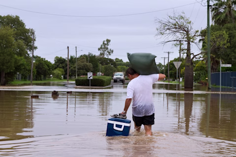 A man walking through a flooded street A man walking through a flooded street