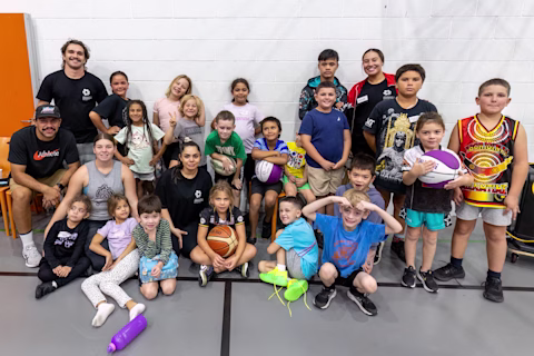 A group of Young, Fit & Deadly participants gathered together indoors smiling A group of Young, Fit & Deadly participants gathered together indoors smiling
