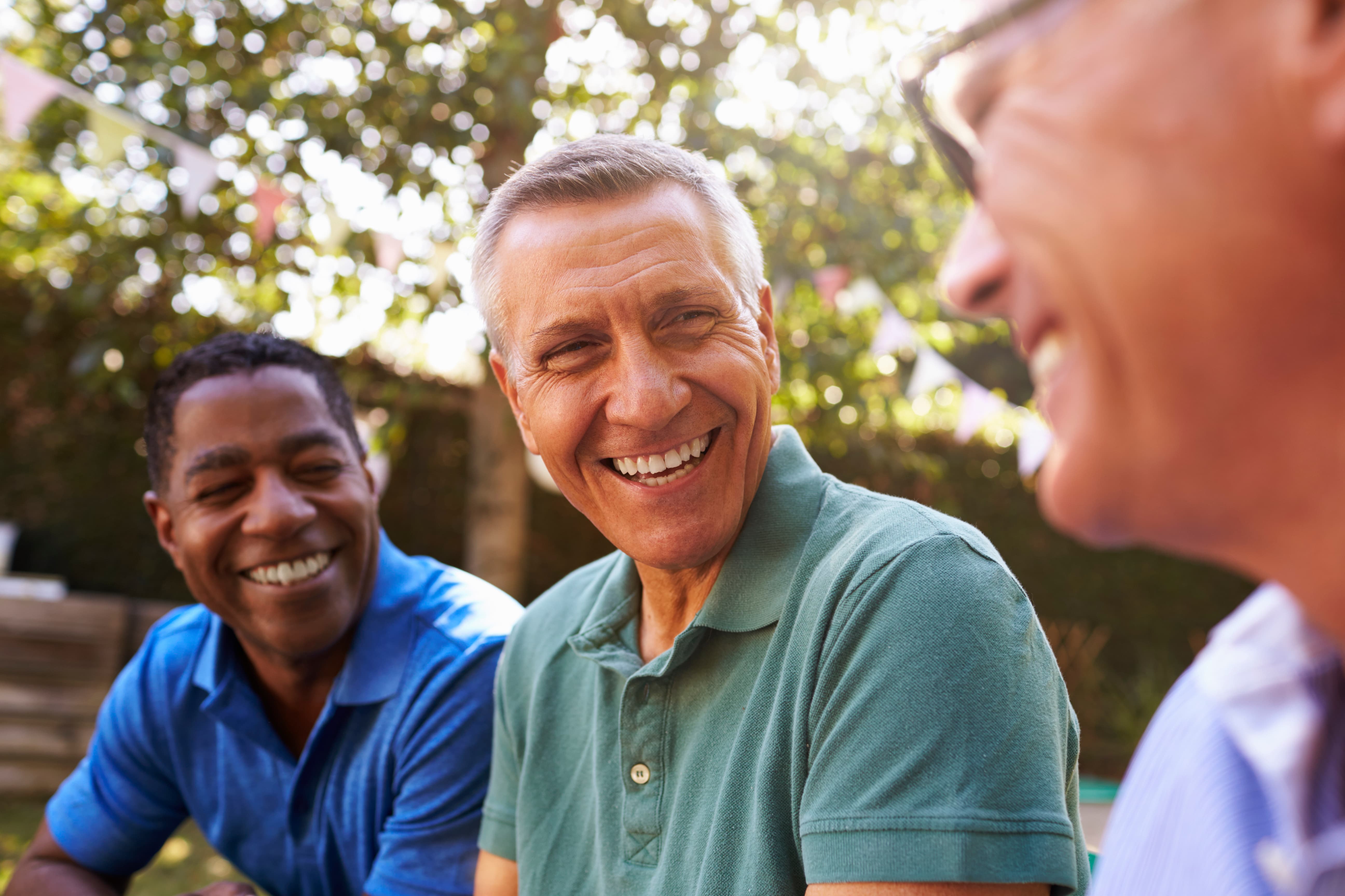 Three men laughing with each other