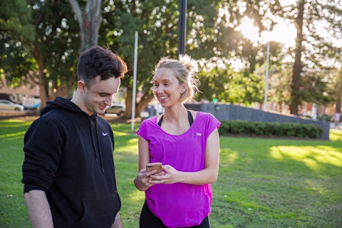 A male and female in exercise clothes out in the park A male and female in exercise clothes out in the park