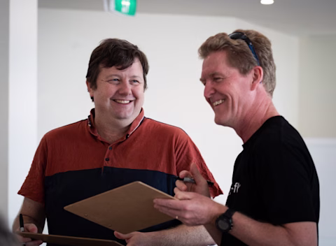 Two male nib employees smiling