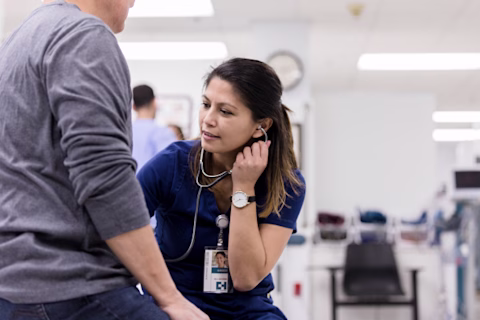 A nurse examining a patient A nurse examining a patient