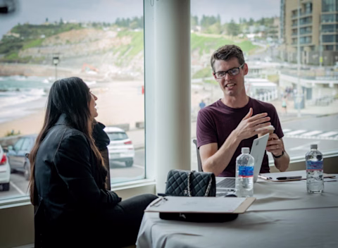 An nib employee workshopping thoughts on paper