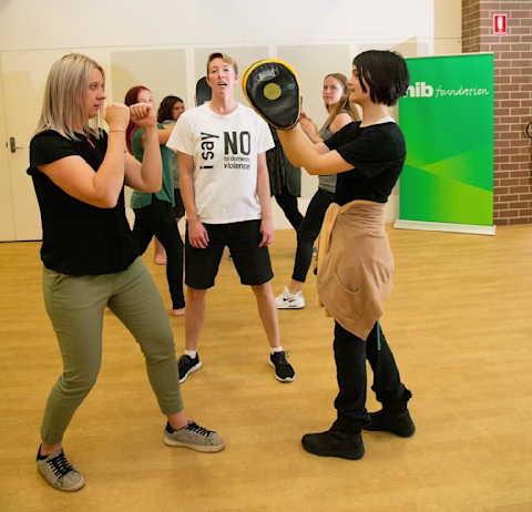 Female teens in a self-defence workshop Female teens in a self-defence workshop