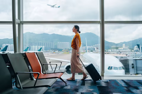 woman in airport with suitcase woman in airport with suitcase