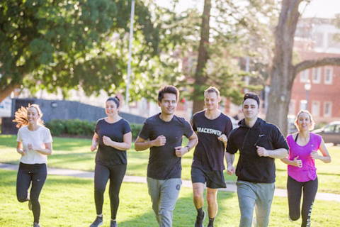 Group of adults running outdoors Group of adults running outdoors