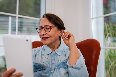 Senior Woman arranging her Hearing Aid