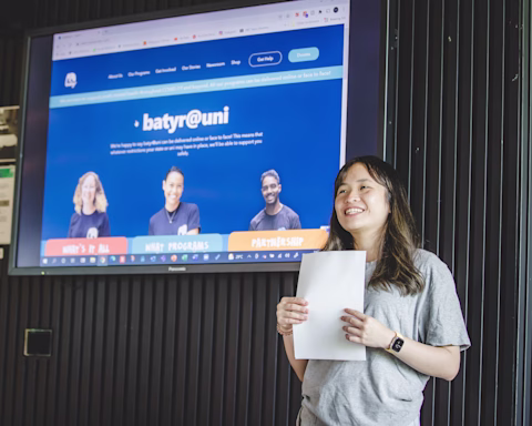 Image of Linh presenting holding a paper Image of Linh presenting holding a paper