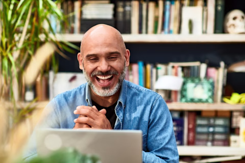 Man laughing and smiling on video conference Man laughing and smiling on video conference