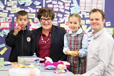 Two young kids in the classroom smiling with their teachers Two young kids in the classroom smiling with their teachers