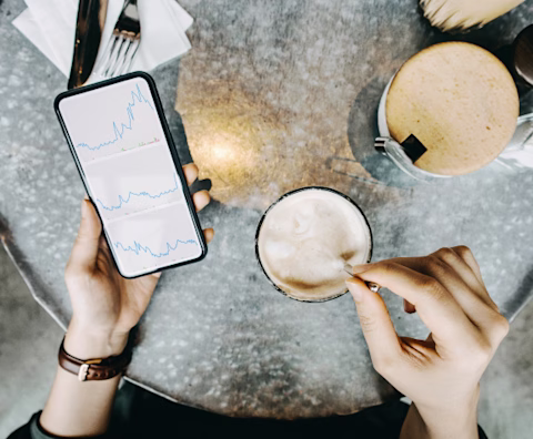 Checking the ASX while holding a cup of coffee Checking the ASX while holding a cup of coffee