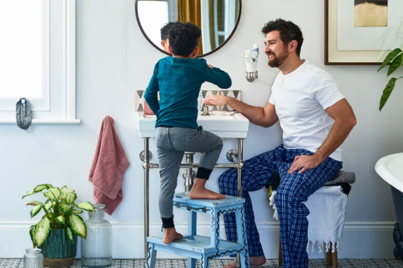 Father and son in the bathroom brushing teeth