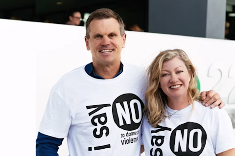 Two adults wearing 'I Say No to Domestic Violence' shirts Two adults wearing 'I Say No to Domestic Violence' shirts