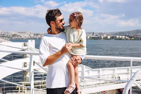 man holding child on boat man holding child on boat