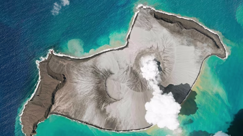 Aerial shot of a volcanic eruption on Tongan island Aerial shot of a volcanic eruption on Tongan island