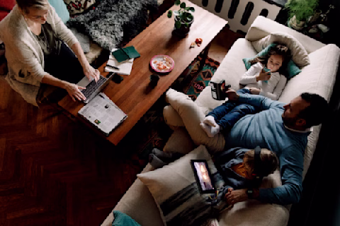 High angle view of family using various technologies in living room at home High angle view of family using various technologies in living room at home