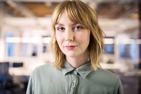 Portrait photograph of young business person in an office. Portrait photograph of young business person in an office.