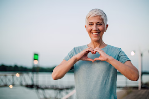 A woman making a heart with her hands A woman making a heart with her hands