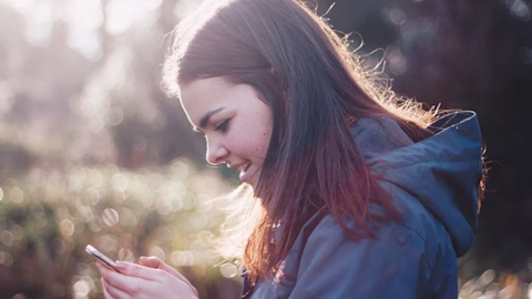 Young female teen looking at her phone Young female teen looking at her phone