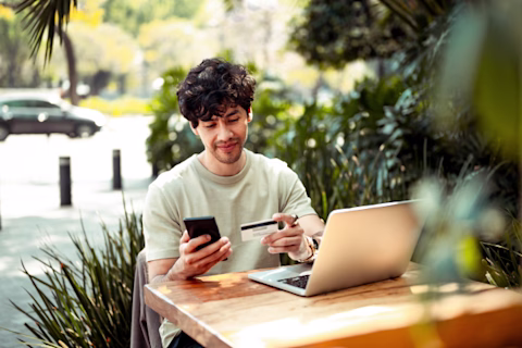 A man on a phone using a laptop A man on a phone using a laptop