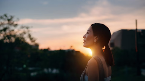 Mother and daughter walking at sunset smiling and enjoying time together Mother and daughter walking at sunset smiling and enjoying time together
