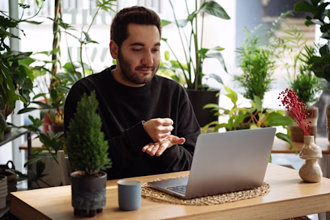 Man using sign language while on a video meeting. Man using sign language while on a video meeting.