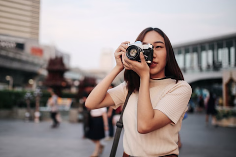 A young woman taking a photo with her camera