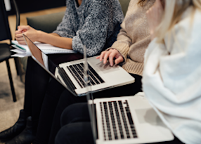 Three people on a computer