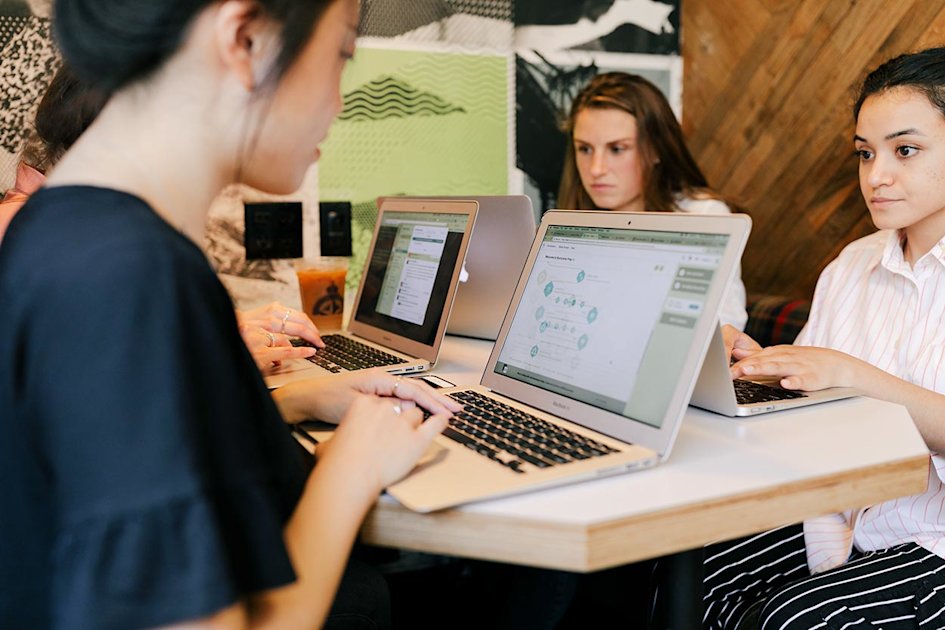 3 students learning to code