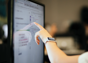 Student pointing at a computer screen