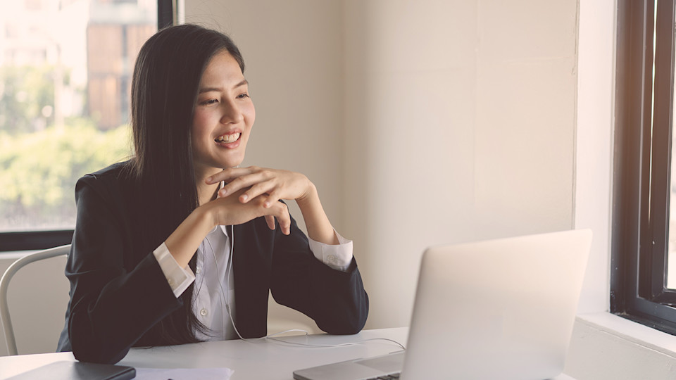 Woman at laptop smiling