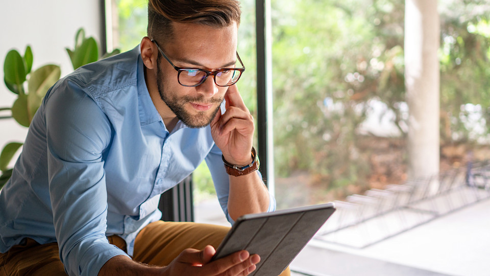 Man at tablet with glasses