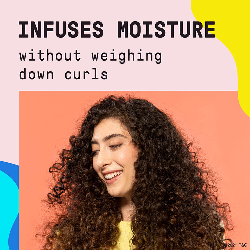 Infuses moisture without weighing down curls. Woman with wavy hair.