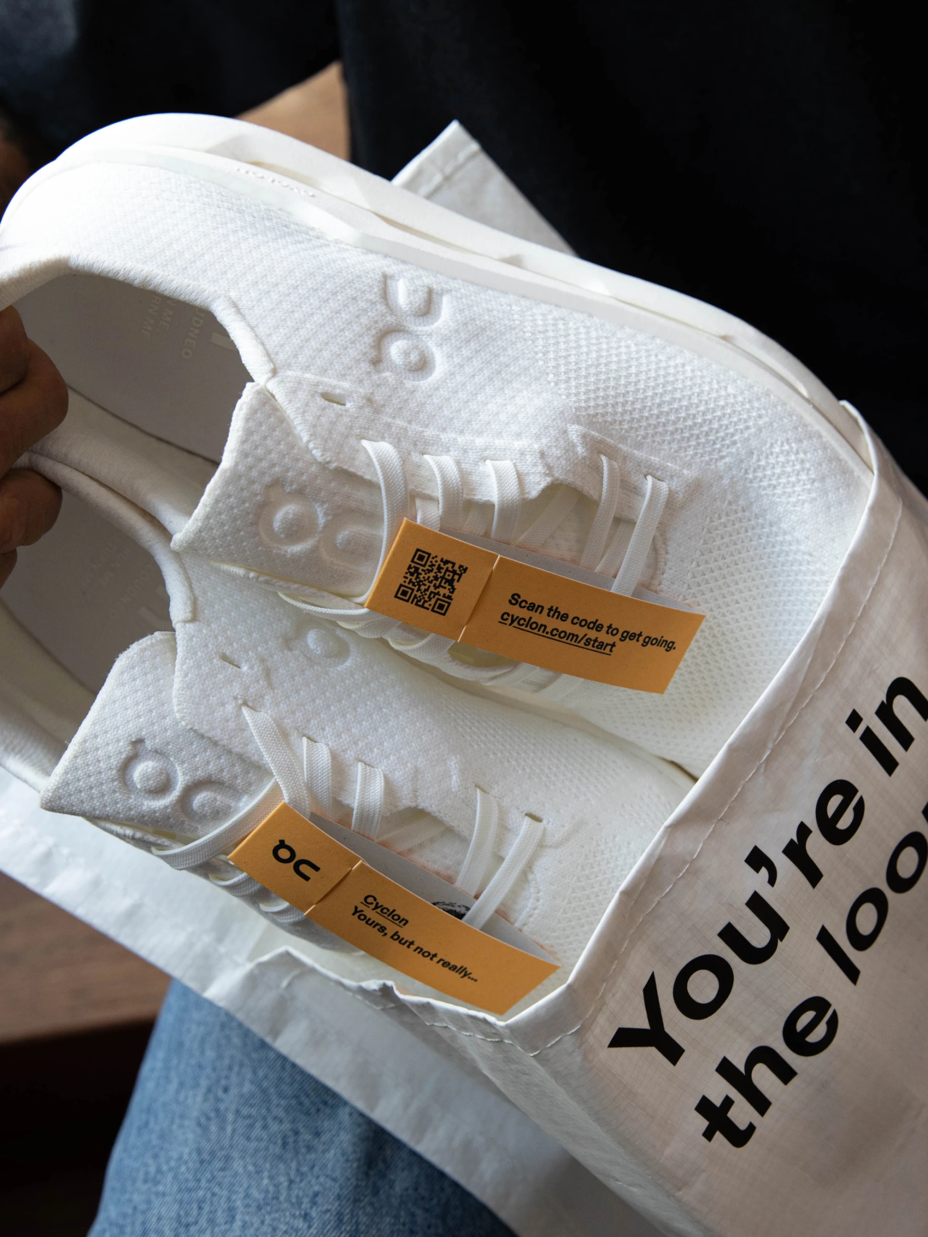 Person removing a clean pair of Cloudneo from the Cyclon bag. 