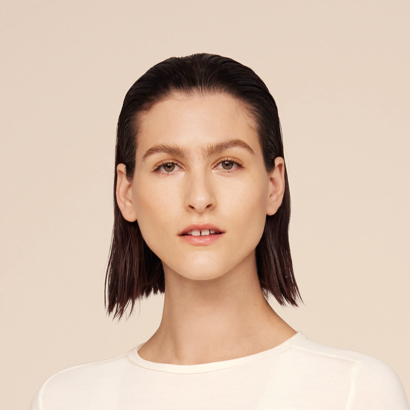 Headshot of Athena, a female model, in a white top. 