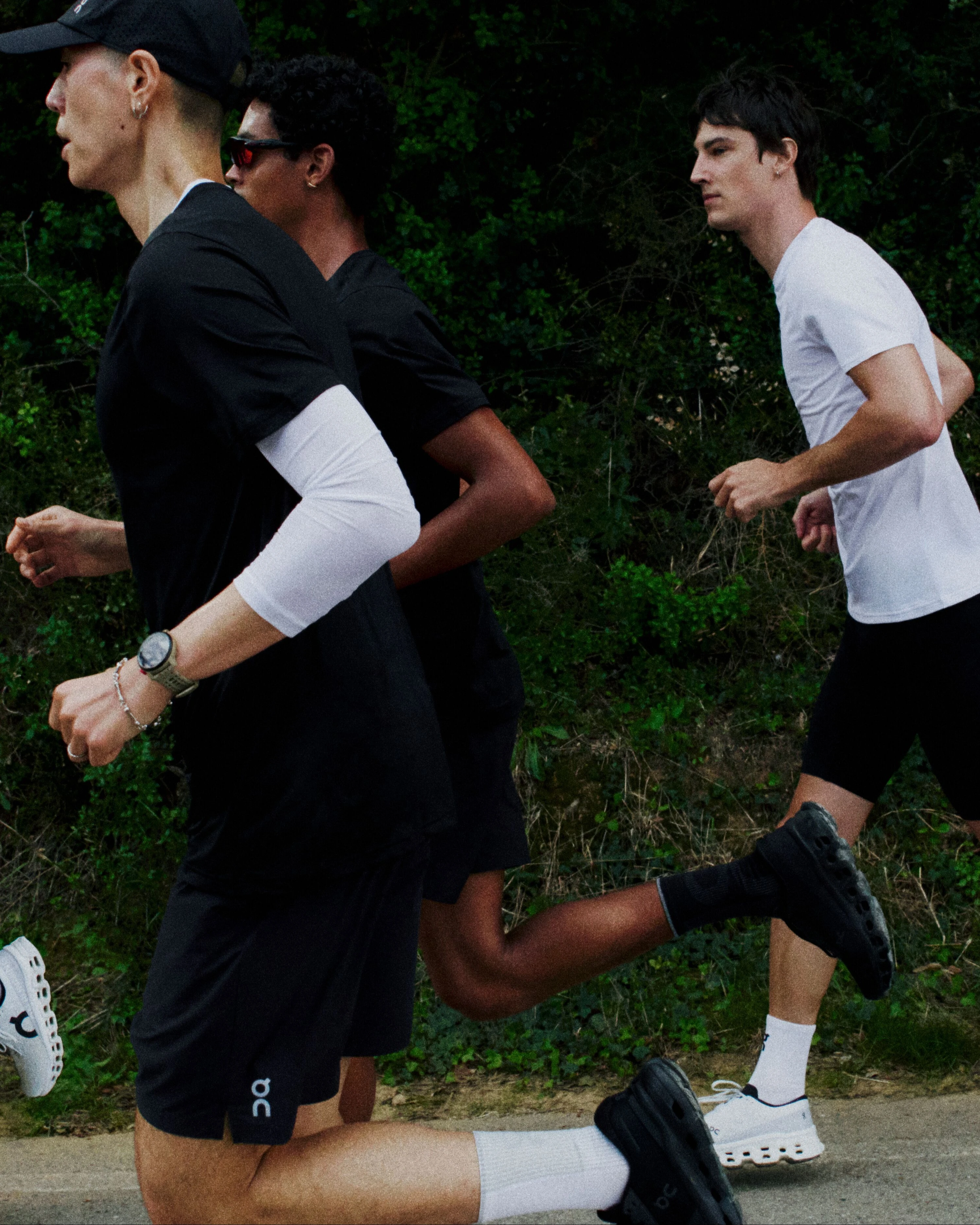 On runners in black and white gear mid-stride.