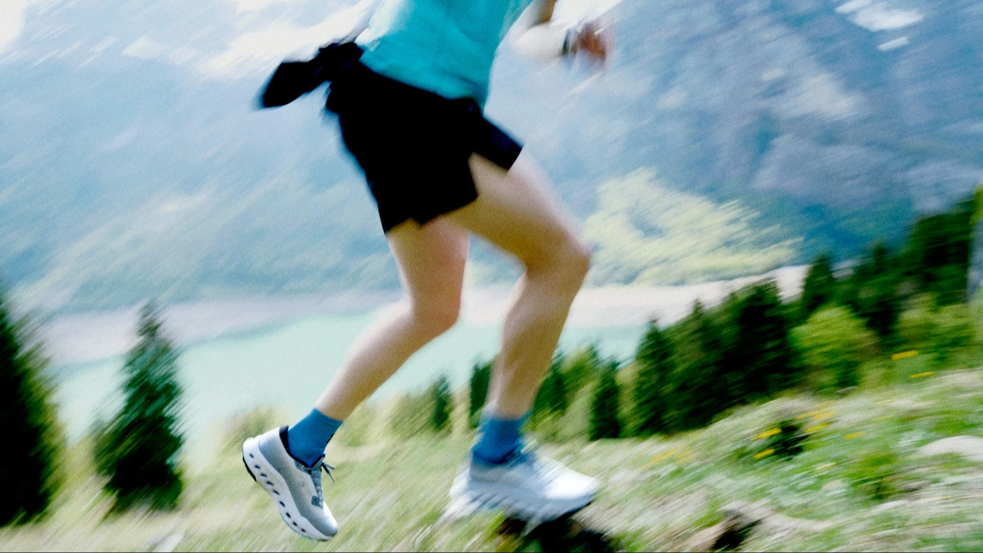 Blurred image of a runner running on a mountain trail.