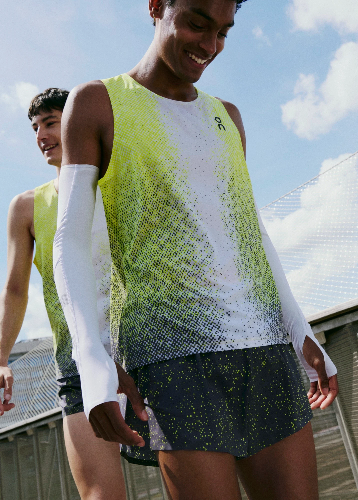 A man in the forefront and background wearing On running gear.