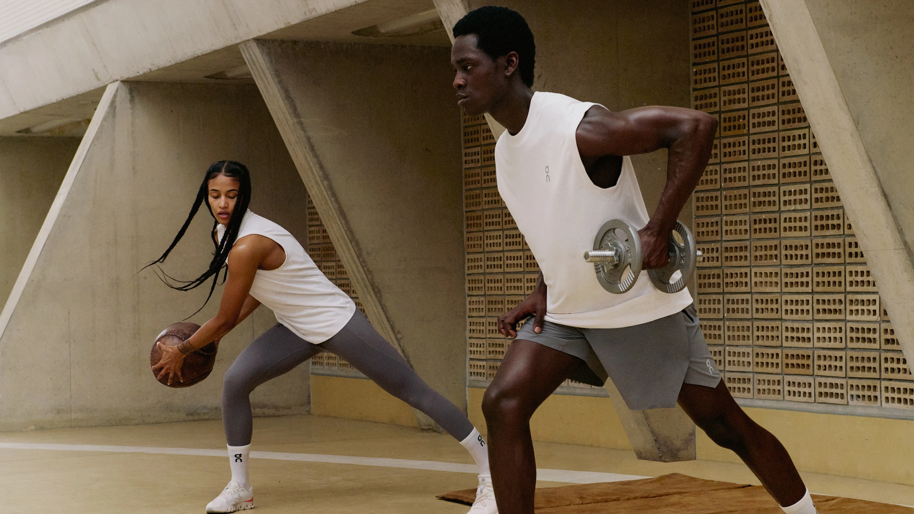 Woman and man wearing training shoes while strength training. 
