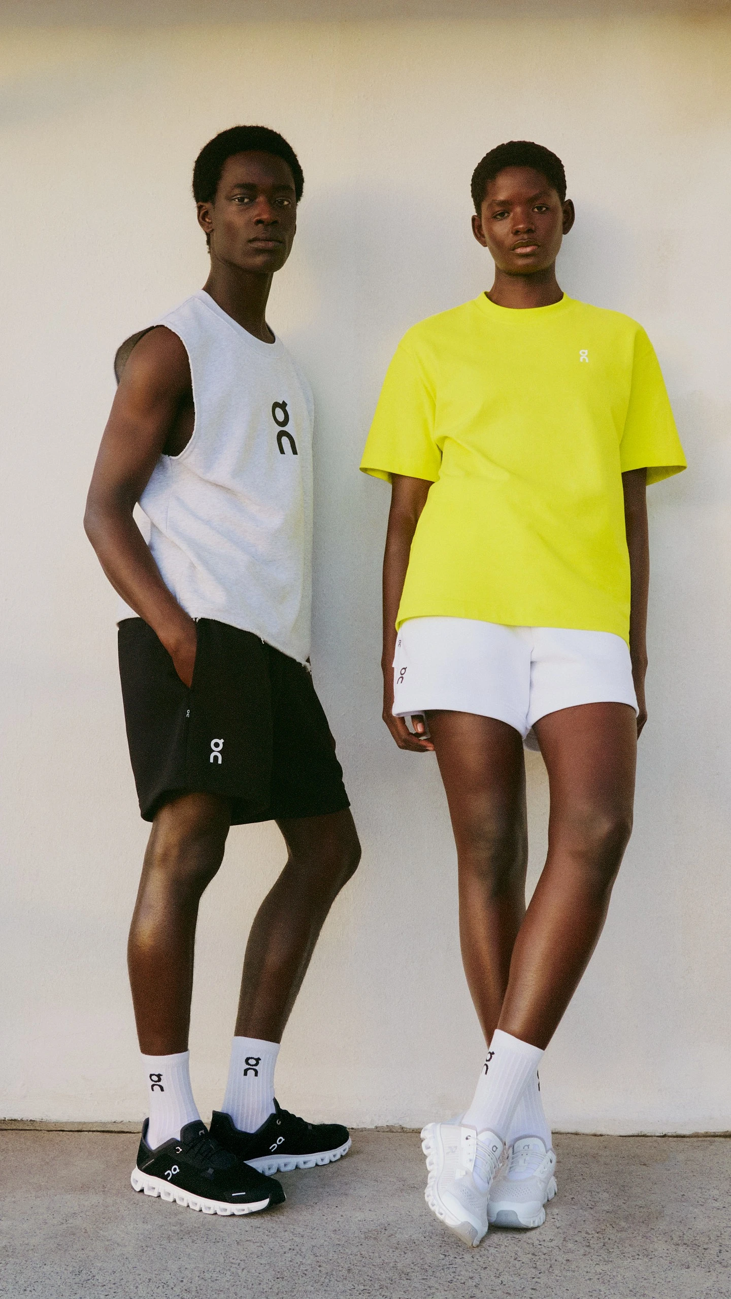 A male and female athlete wearing On shorts, showcasing fit and length for a guide on how to measure inseam on shorts.