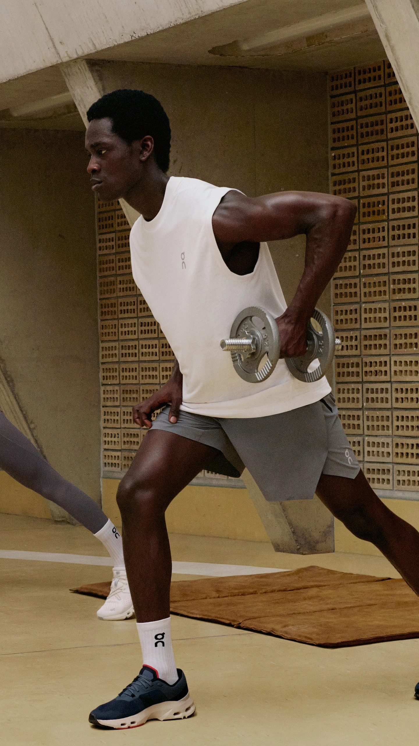 Woman and man wearing training shoes while strength training. 