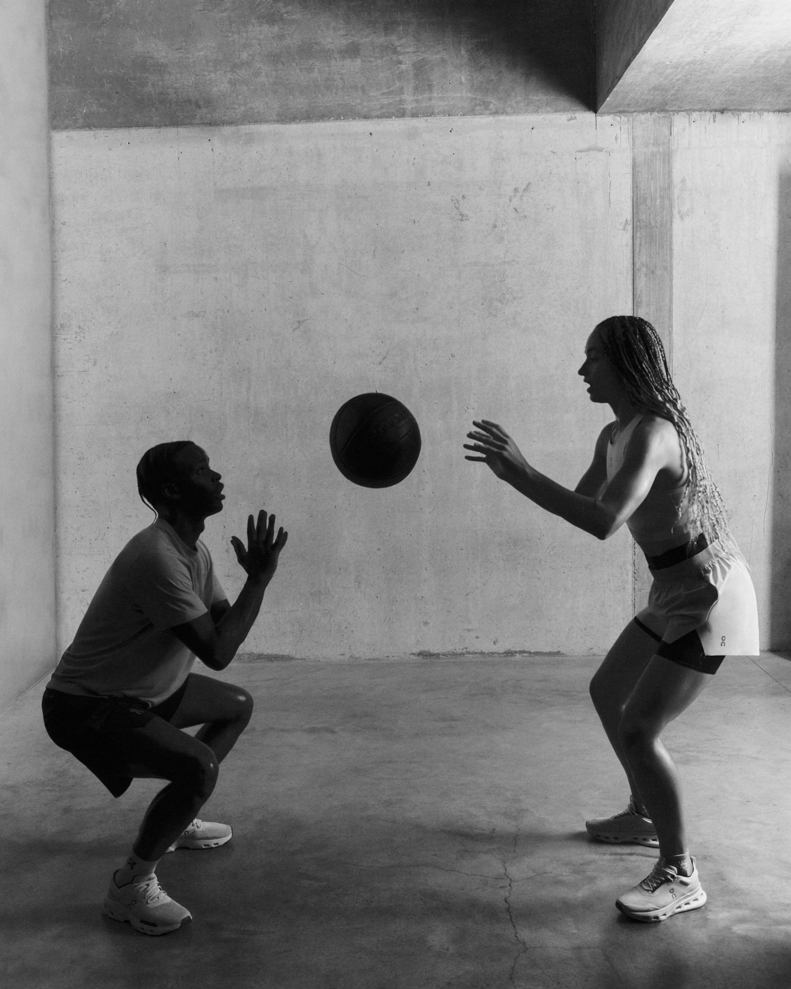 Two athletes performing medicine ball throws. 
