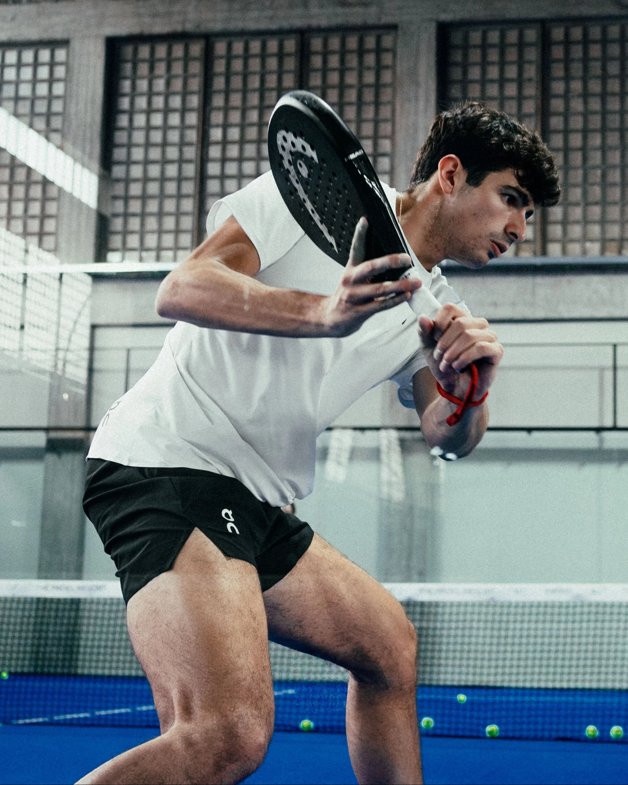 A padel player in On gear swings their padel.